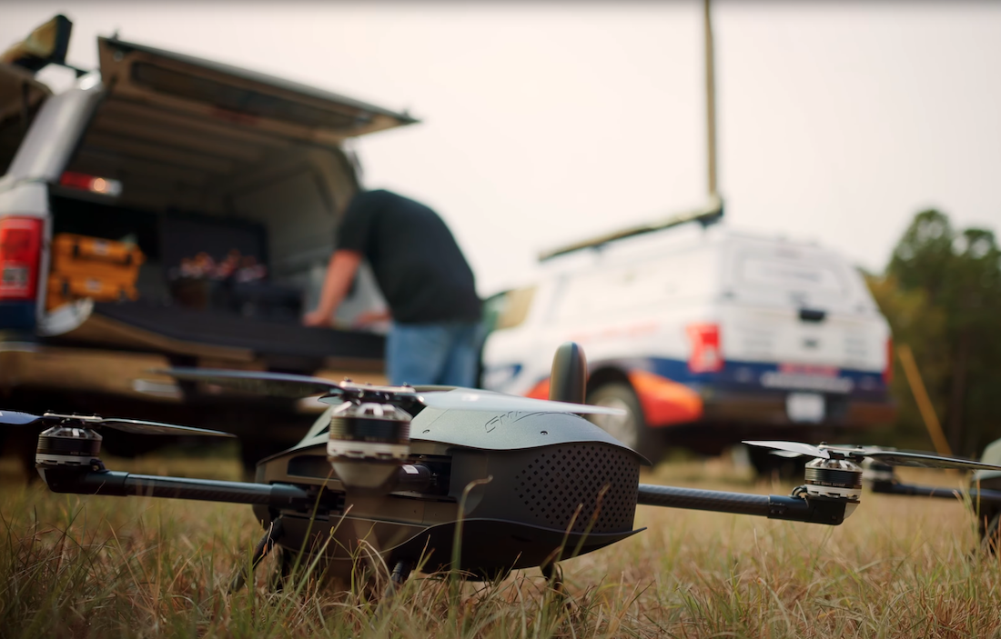 A Discovery 3 mapping drone is on the ground while a field application prepares to fly it.