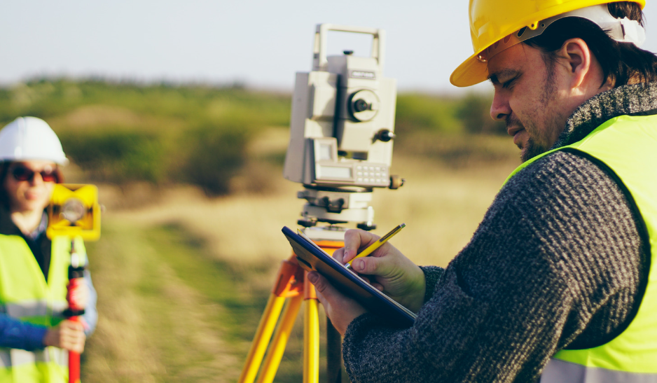 A man using a base and rover to perform land surveying