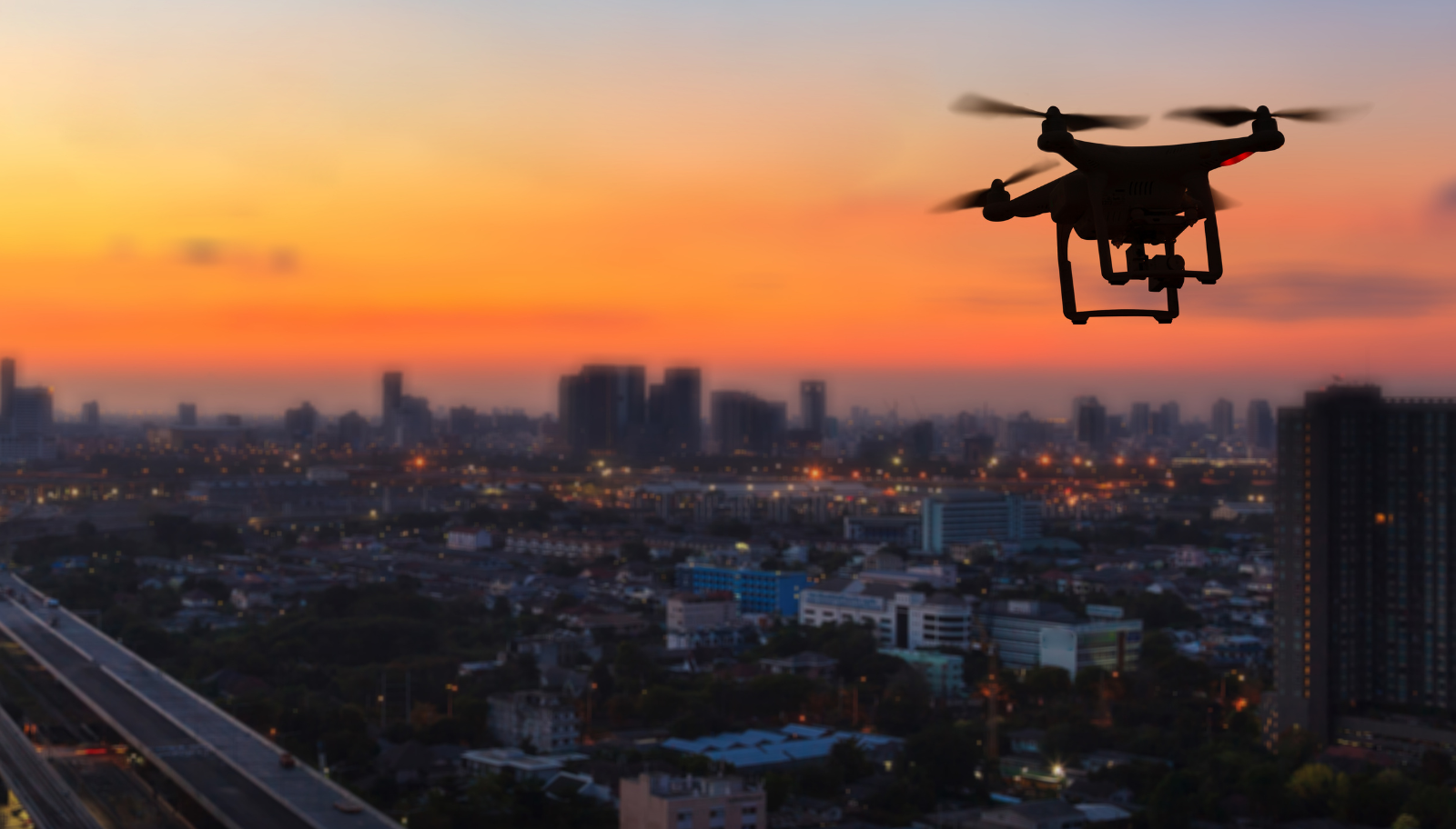 Drone topographic survey capturing survey-grade terrain data over a large vegetated site for land surveying.